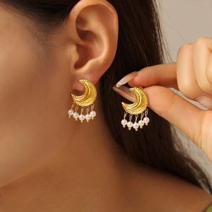 Elegant gold moon earrings with hanging pearl tassels and irregular geometric metal finish
