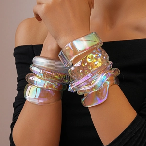 Detailed view of iridescent acrylic resin bangles with striped and wavy textures on a model