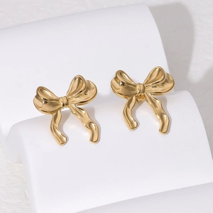 Minimalist 18K gold plated bow stud earrings made of stainless steel on white display
