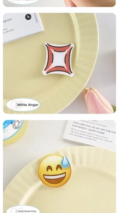 Detailed view of yellow emoji water drop acrylic clips and white anger symbol hairpins