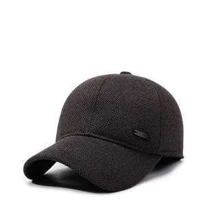 Close-up of winter baseball cap with thick wool texture and metallic brand plaque detail