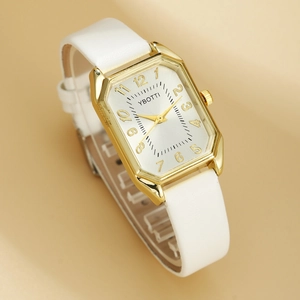Detail of white leather strap watch with gold octagonal case and sparkling silver dial