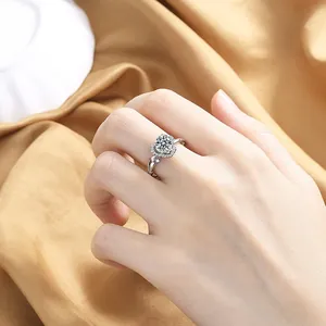 Detailed view of an open heart zircon engagement ring on elegant silk background