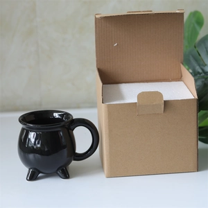 Cauldron coffee mug with eco-friendly kraft box and foam insert on marble background