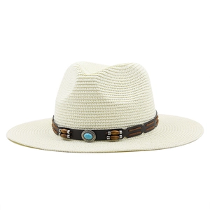 Close-up of woven straw fedora with brown leather band and turquoise stone detail
