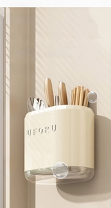 Detail of wall-mounted kitchen utensil holder with transparent drainage tray and partitions