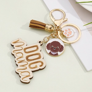 Detail of colorful tassel keychain with wooden Dog Mom tag and Poodle charm