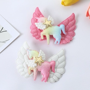 Glittery angel wing unicorn hair clips for girls in pink and white pastel colors