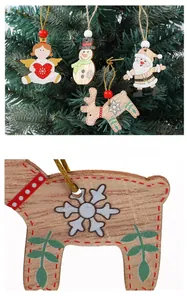Macro detail of hand-painted wooden Christmas angel and reindeer tree ornaments