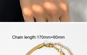 Detail of golden snake chain showing lobster clasp and adjustable extension links