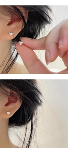 Close-up of minimalist S925 sterling silver heart studs shown on ear for realistic scale