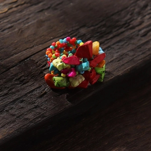 Macro detail of Bohemian ring made with multi-color natural stones and seed beads