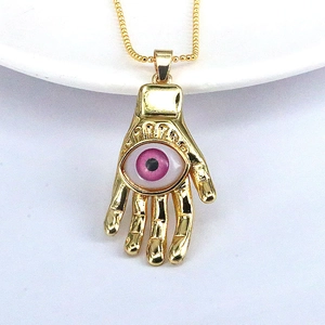 Golden Hamsa Hand necklace with pink Evil Eye resin pendant on a delicate beaded chain