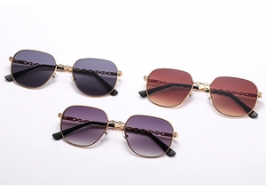 Detailed view of square metal sunglasses with chic chain-link temples and tinted lenses