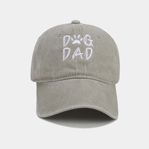 Detailed close-up of DOG DAD embroidery on washed grey cotton vintage baseball cap
