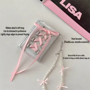 Silver ballet-style trifold wallet with pink ribbon lace and pearl handle strap