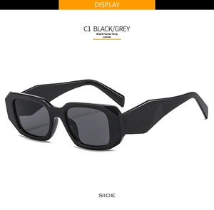 Detail view of stylish square sunglasses with thick black frames and grey lenses at 45-degree angle