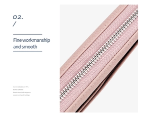 Detail of pink genuine leather wallet showing smooth silver zipper and fine stitching