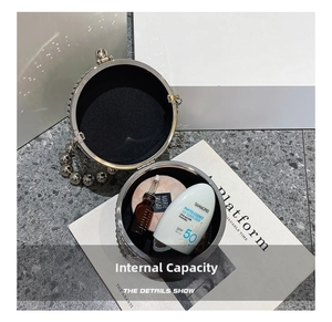 Interior view showing capacity of a crystal bucket evening bag with pearl chain handle