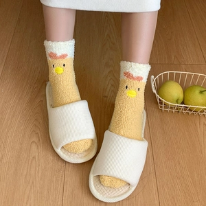 Detail of soft yellow coral fleece thermal socks with cute 3D cartoon chick embroidery