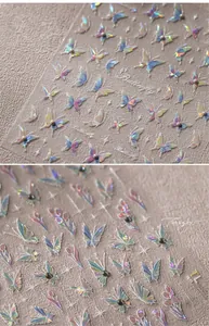 Macro detail of 3D holographic laser nail art stickers with butterfly and flower designs