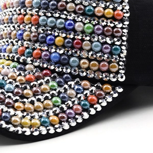 Detailed macro view of colorful beads and shiny rhinestones on a black baseball cap