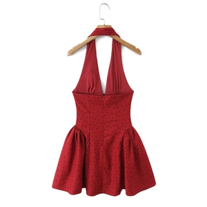 Detail of red halter neck dress with black flocked polka dots and back invisible zipper