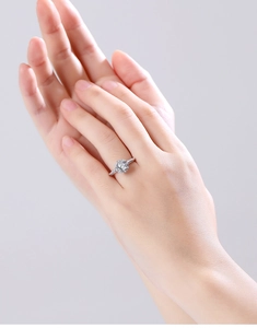 Detailed view of 925 silver angel wing ring with round center stone and halo setting