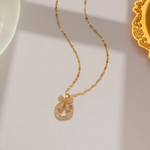 Detailed close-up of a gold butterfly necklace with shimmering micro-pave cubic zirconia
