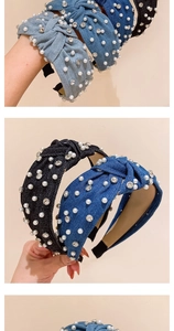 Detailed close-up of denim knotted headband with hand-stitched pearls and rhinestones