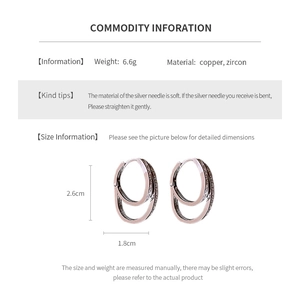 Detail view of double-layered zircon earrings with size specs and copper material info