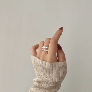 Detail of 925 sterling silver ring with irregular chain texture on model's hand