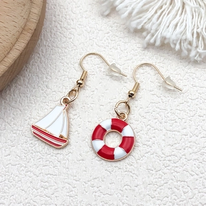Nautical theme gold metal earrings with sailboat and lifebuoy red white enamel pendants