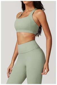 Dettaglio del set yoga verde salvia con leggings a vita alta e reggiseno sportivo