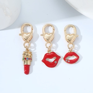Detailed view of red lipstick and red lip charms with crystals and heart-shaped clasps
