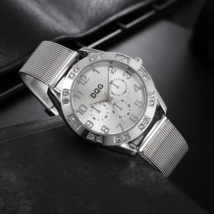 Detailed close-up of a silver DQG watch with a crystal bezel and mesh metal strap