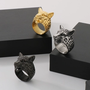 Detailed view of three punk viking wolf head rings in gold, silver, and black finishes