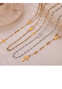 Detailed view of silver and gold religious rosary necklaces with cross pendants