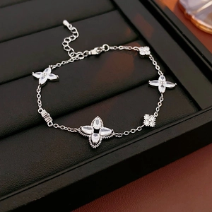Detailed view of silver flower bracelet with clear zircons on black leather jewelry tray