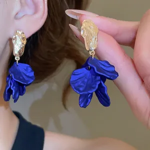 Modern acrylic flower petal tassel earrings with golden hammered texture and blue finish