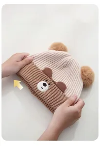 Detailed view showing high elasticity of this cute cartoon baby knit hat in beige