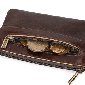 Detail of dark brown leather coin purse with double metal zippers and multi-slots