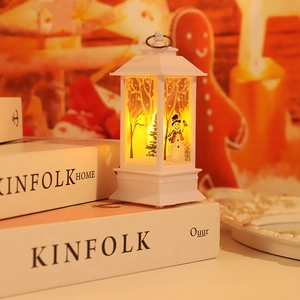Close-up of white LED Christmas lantern with snowman scene and warm glowing light