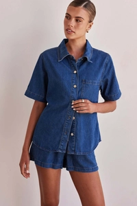 Detail view of navy blue washed denim two-piece set showing short sleeve shirt and shorts