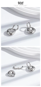Detail view of detachable croissant-style twist hoop earrings in silver finish