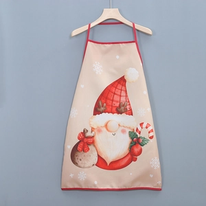Detail of Christmas gnome apron featuring festive prints and red trim on a wooden hanger