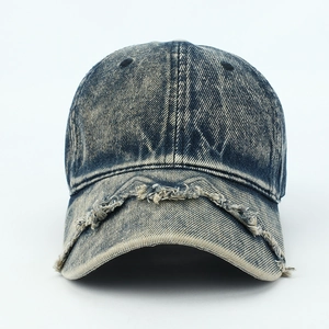 Close-up of distressed edges and frayed denim texture on a vintage washed baseball cap