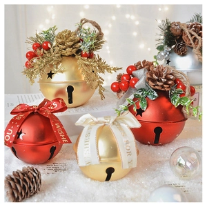 Close-up of matte Christmas bells with pine cones, berries, and Best Wishes ribbons