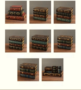 Detailed grid of vintage faux book storage boxes and pen holders with gold floral patterns