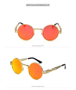 Detail view of round steampunk sunglasses with gold metal frame and red mirror lenses